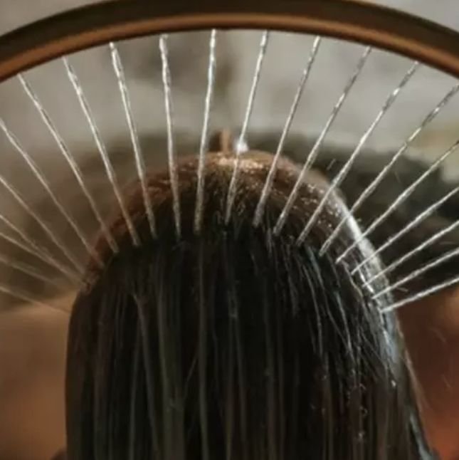 A scalp massager during a hair spa treatment