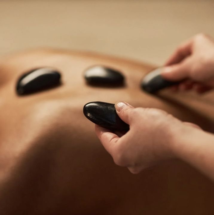 Warm stones placed along the back during a hot stone massage